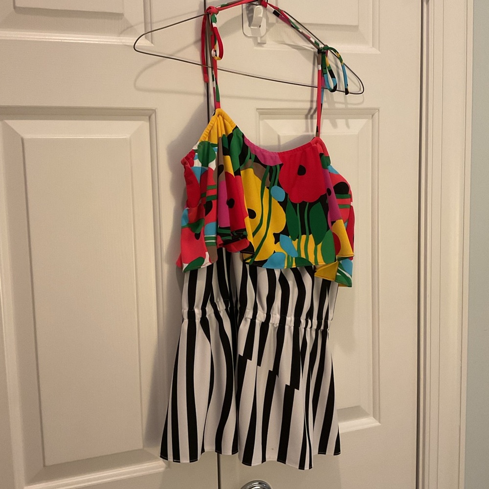 Black/white striped top with shoulder tie straps. Floral print. 100% polyester.